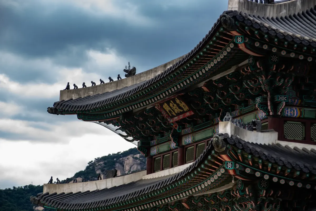 Stunning view of Gwanghwamun Gate showcasing traditional Korean architecture against a cloudy sky.